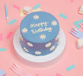 Mini Filled Sponge Cake With Daisies In Light Blue On A Pink Background